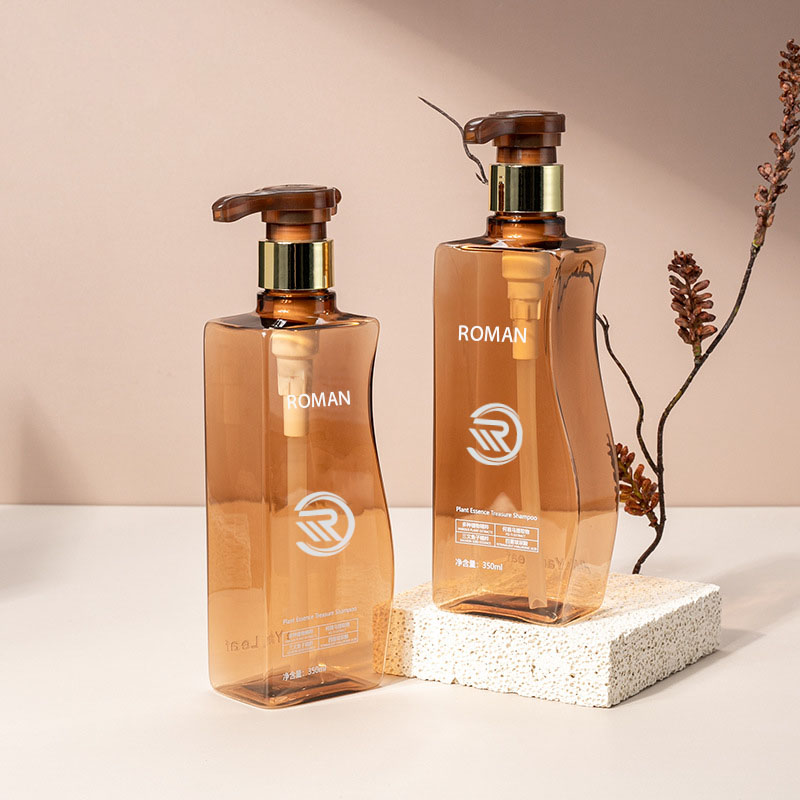 信頼性の高い 350 ミリリットル 500 ミリリットル曲線状の琥珀色のペットプラスチック空のボディローションボトル、ポンプ付き、ヘアケアシャンプーコンディショナーまたはフェイスクリーム用